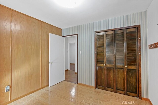 unfurnished bedroom featuring light hardwood / wood-style floors and a closet