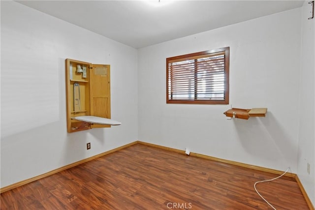 unfurnished room with hardwood / wood-style floors