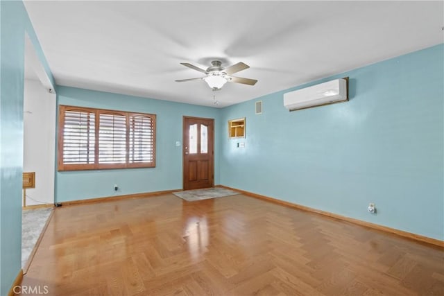 foyer entrance with a wall unit AC, light parquet floors, and ceiling fan