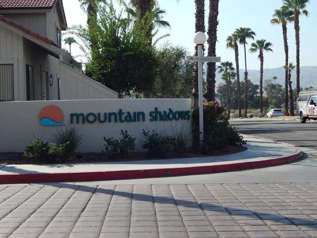 community sign with a mountain view