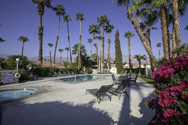 view of pool with a mountain view and a patio