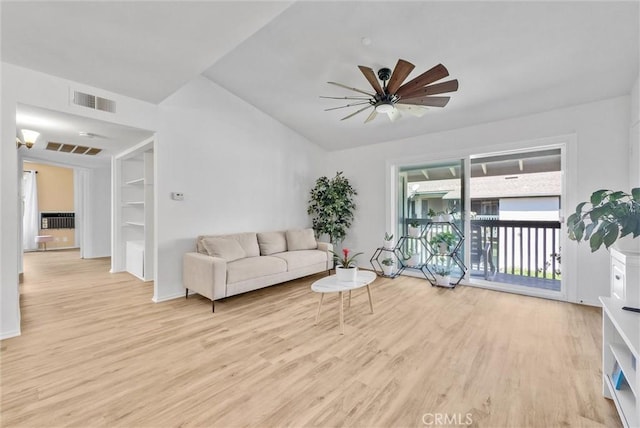 living room featuring light hardwood / wood-style floors, ceiling fan, and vaulted ceiling