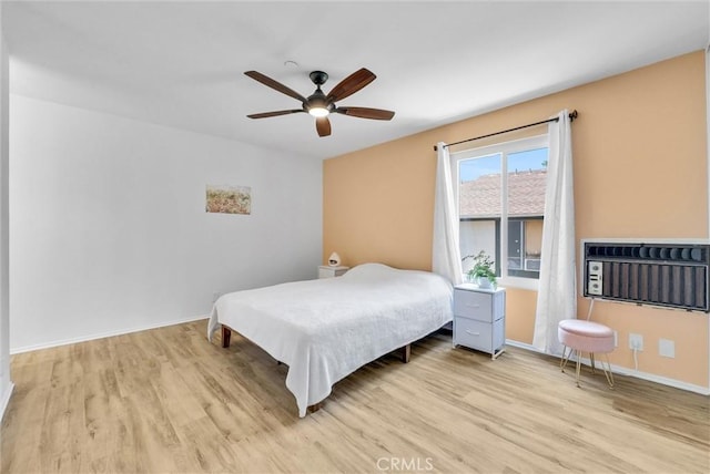 bedroom with ceiling fan and light hardwood / wood-style floors