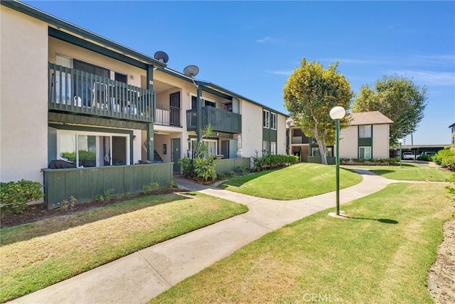 view of property's community with a lawn