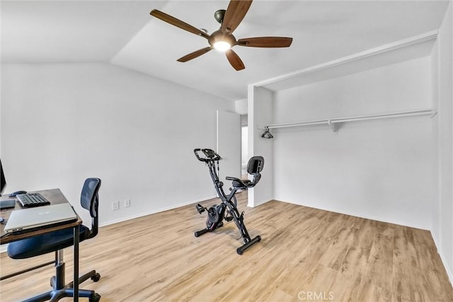 exercise room with lofted ceiling, ceiling fan, and light hardwood / wood-style flooring