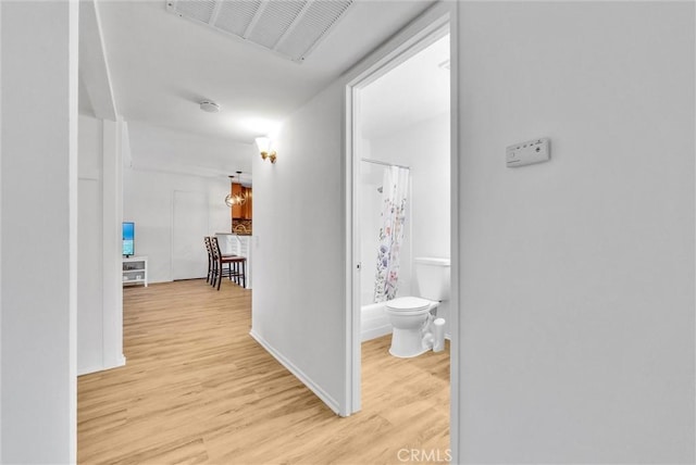 corridor with light hardwood / wood-style flooring