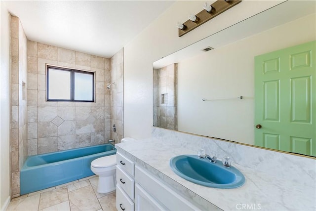 full bathroom featuring tiled shower / bath combo, vanity, and toilet