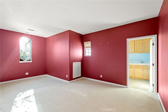 carpeted spare room featuring a healthy amount of sunlight