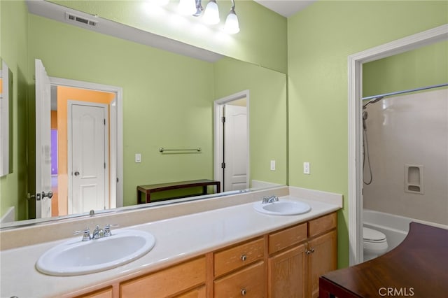 full bathroom featuring toilet, vanity, and shower / tub combination