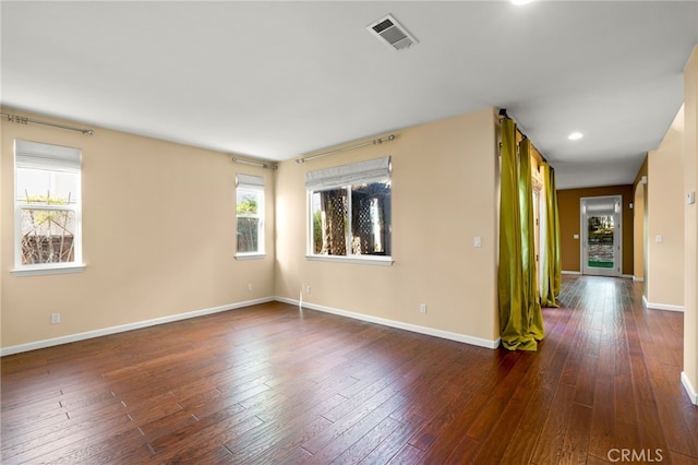 spare room with dark hardwood / wood-style floors