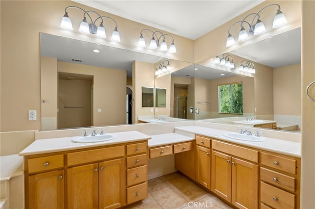 bathroom featuring tile patterned floors, an enclosed shower, and vanity