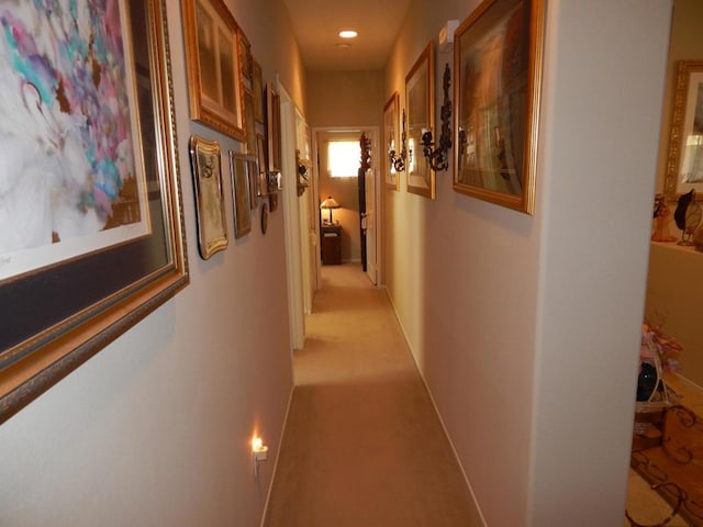 hallway with light colored carpet