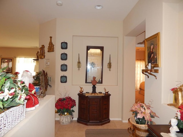 hall featuring light tile patterned floors