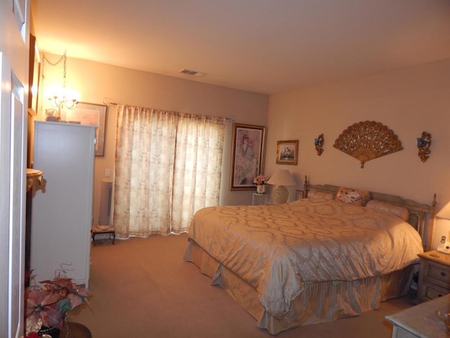 carpeted bedroom with a chandelier