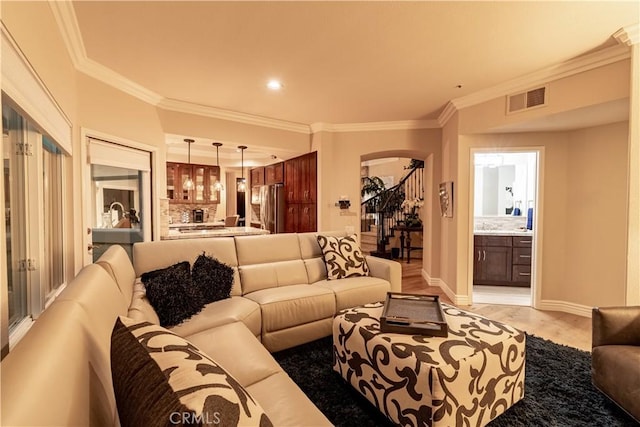 living room with light hardwood / wood-style floors and ornamental molding