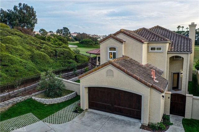 mediterranean / spanish-style home with a garage