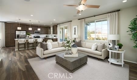 living room featuring ceiling fan and hardwood / wood-style flooring