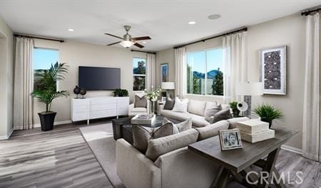 living room featuring ceiling fan, a healthy amount of sunlight, and hardwood / wood-style flooring