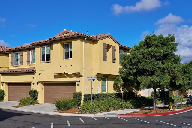 mediterranean / spanish-style home featuring a garage