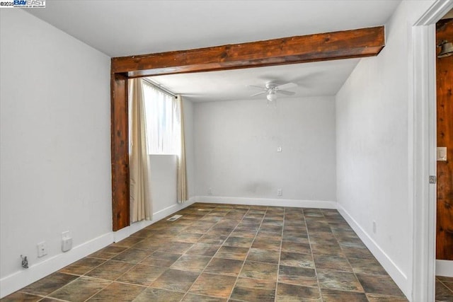 empty room featuring ceiling fan and beam ceiling