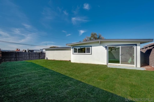 rear view of house with a lawn