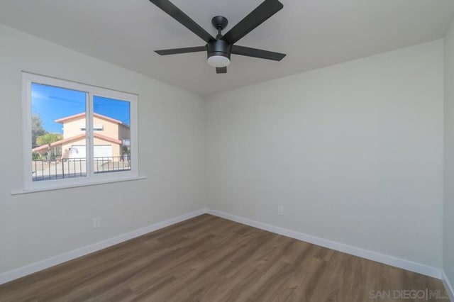 empty room with ceiling fan and hardwood / wood-style floors