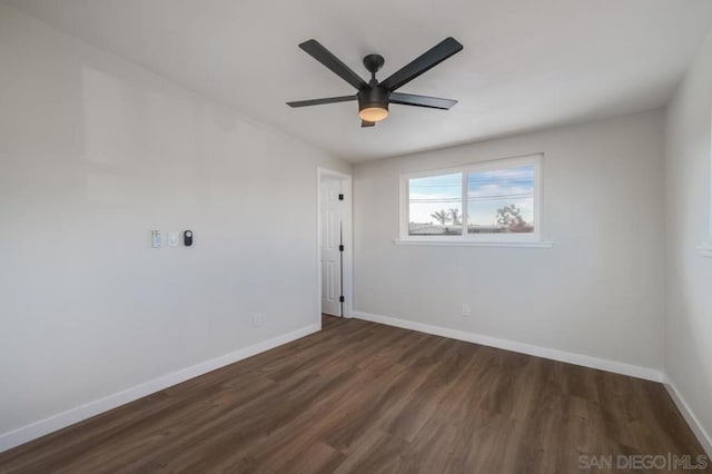 empty room featuring ceiling fan and dark hardwood / wood-style flooring