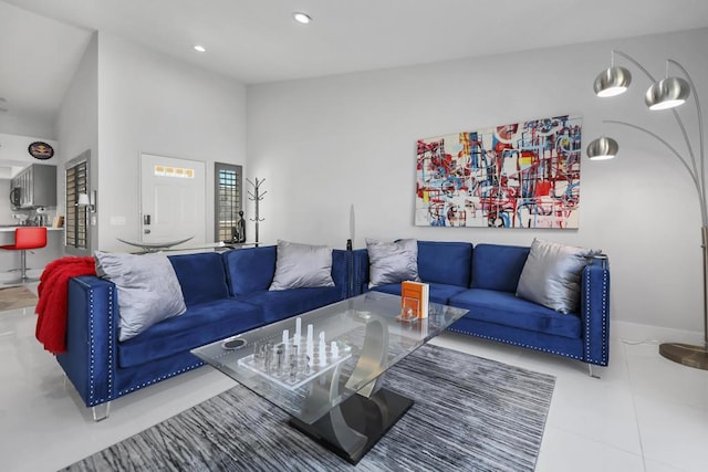 living room featuring lofted ceiling and tile patterned floors