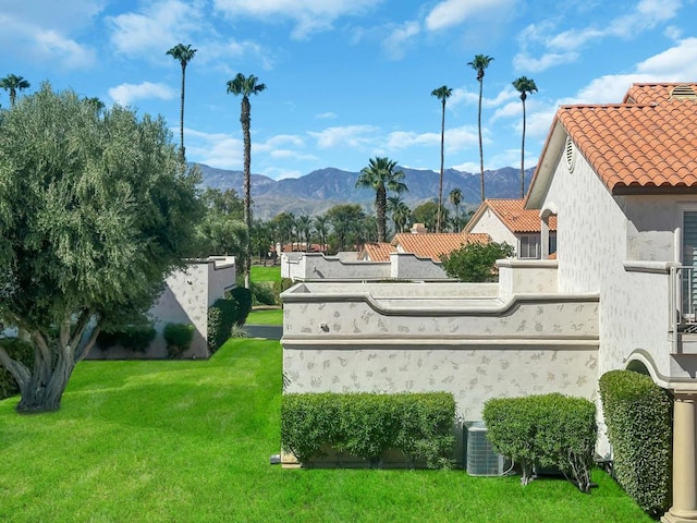 community / neighborhood sign featuring a lawn and a mountain view