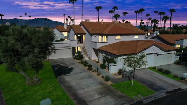 view of front facade with a mountain view and a lawn