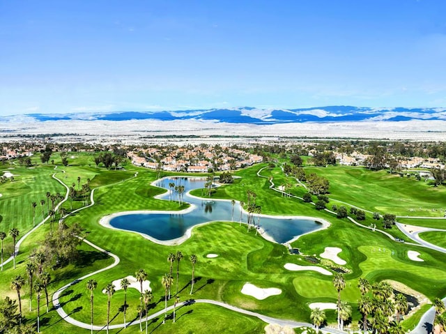 surrounding community with a water and mountain view