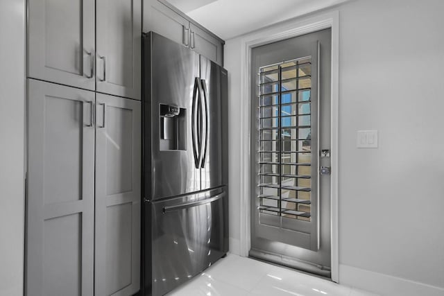 kitchen featuring stainless steel fridge with ice dispenser and gray cabinets