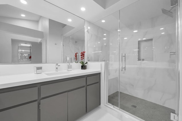 bathroom featuring an enclosed shower and vanity