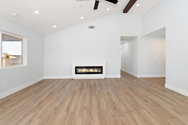 unfurnished living room with light hardwood / wood-style floors, ceiling fan, high vaulted ceiling, and beamed ceiling