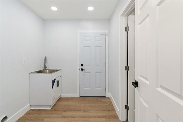 interior space featuring light wood-type flooring and sink