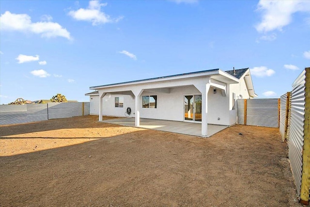 back of house with a patio