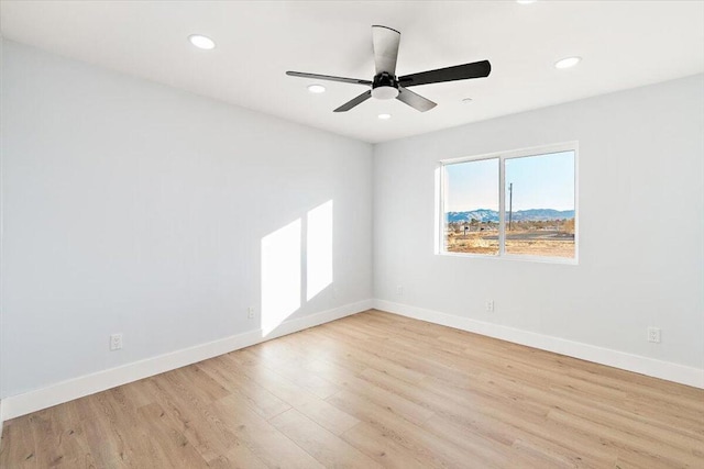 unfurnished room with ceiling fan and light hardwood / wood-style flooring