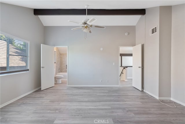 unfurnished bedroom with beamed ceiling, light hardwood / wood-style floors, high vaulted ceiling, ceiling fan, and ensuite bathroom