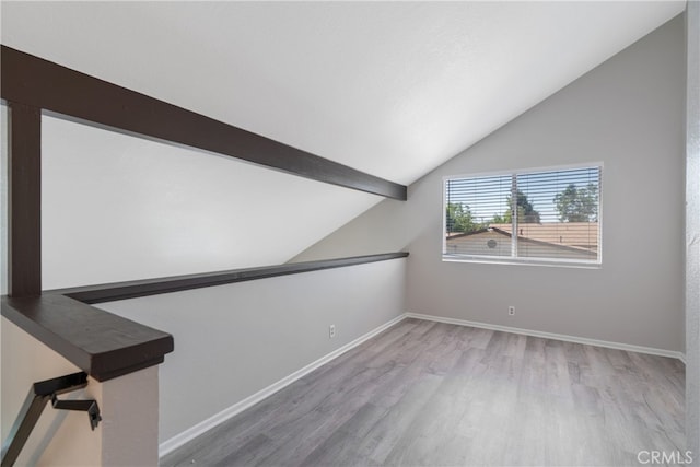 interior space featuring vaulted ceiling with beams and hardwood / wood-style flooring