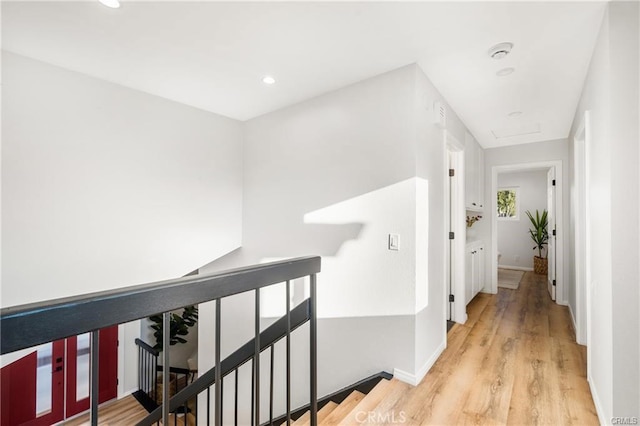 corridor with light hardwood / wood-style flooring