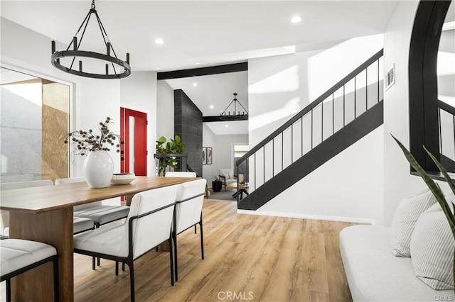 dining area featuring light hardwood / wood-style flooring and lofted ceiling with beams