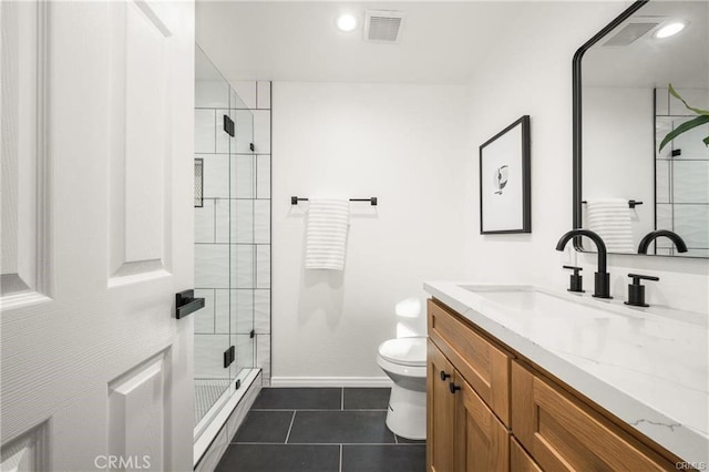 bathroom with tile patterned floors, toilet, vanity, and an enclosed shower