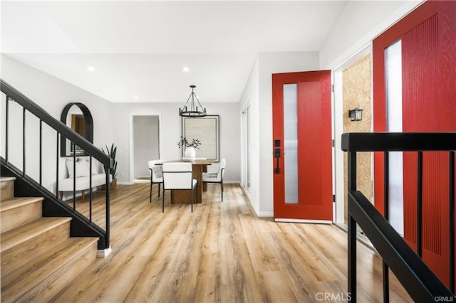 entryway with a notable chandelier and light hardwood / wood-style floors