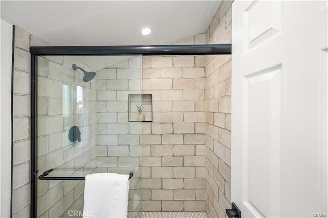 bathroom featuring a shower with shower door