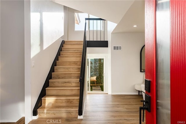 staircase featuring wood-type flooring