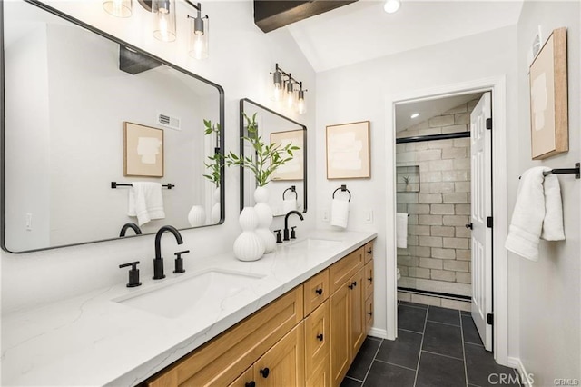 bathroom featuring a shower with shower door, vanity, lofted ceiling with beams, and tile patterned floors