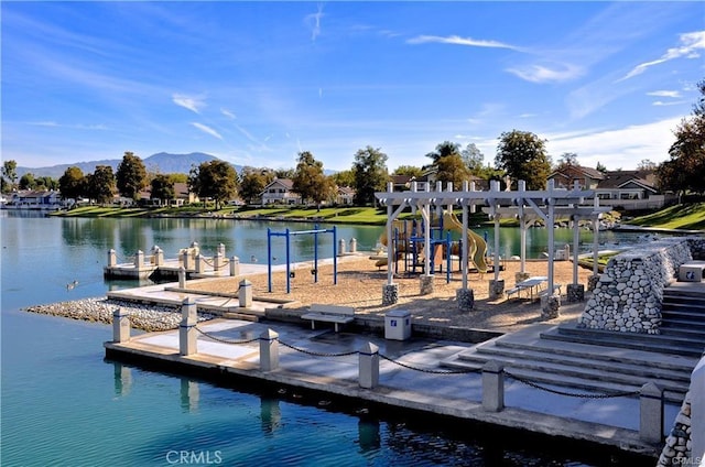 dock area with a playground and a water and mountain view