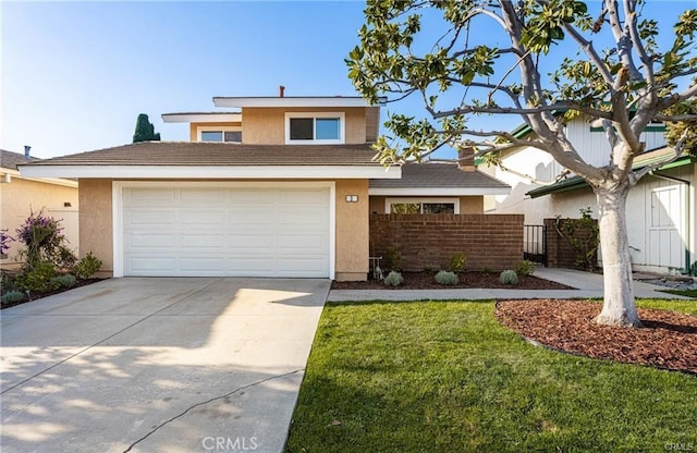 view of front of home with a front yard and a garage