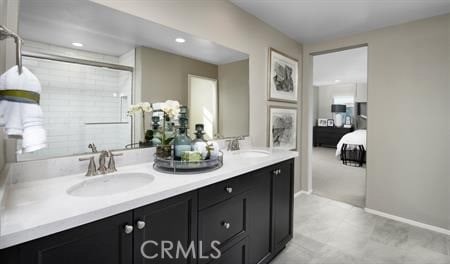 bathroom featuring a shower with shower door and vanity