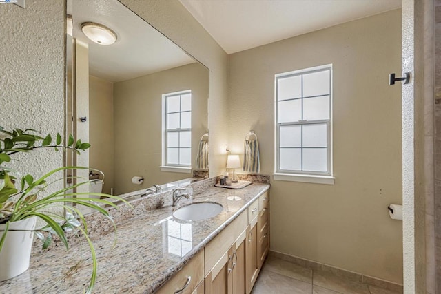 bathroom featuring tile patterned flooring and vanity